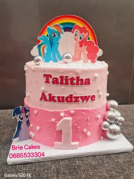 Pink first birthday pony-themed cake by Brie Cakes